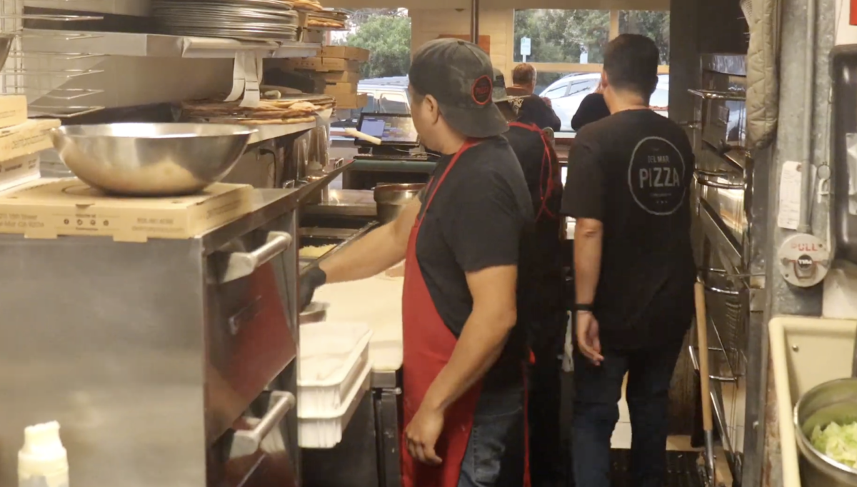 Cooks inside Del Mar Pizza prepare food for their customers. Del Mar Pizza opened in 1989. Photo courtesy of Hajin Park.